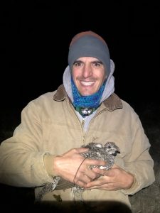 Joshua Uriarte holding a sage-grouse